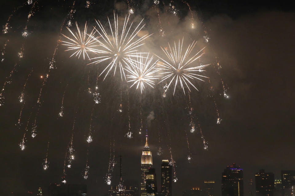 Fireworks fill the sky around New York City's Empire State Building.