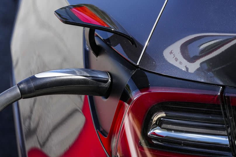 An electric vehicle receives a charge at a charging station in Woodstock, GA, September 2023