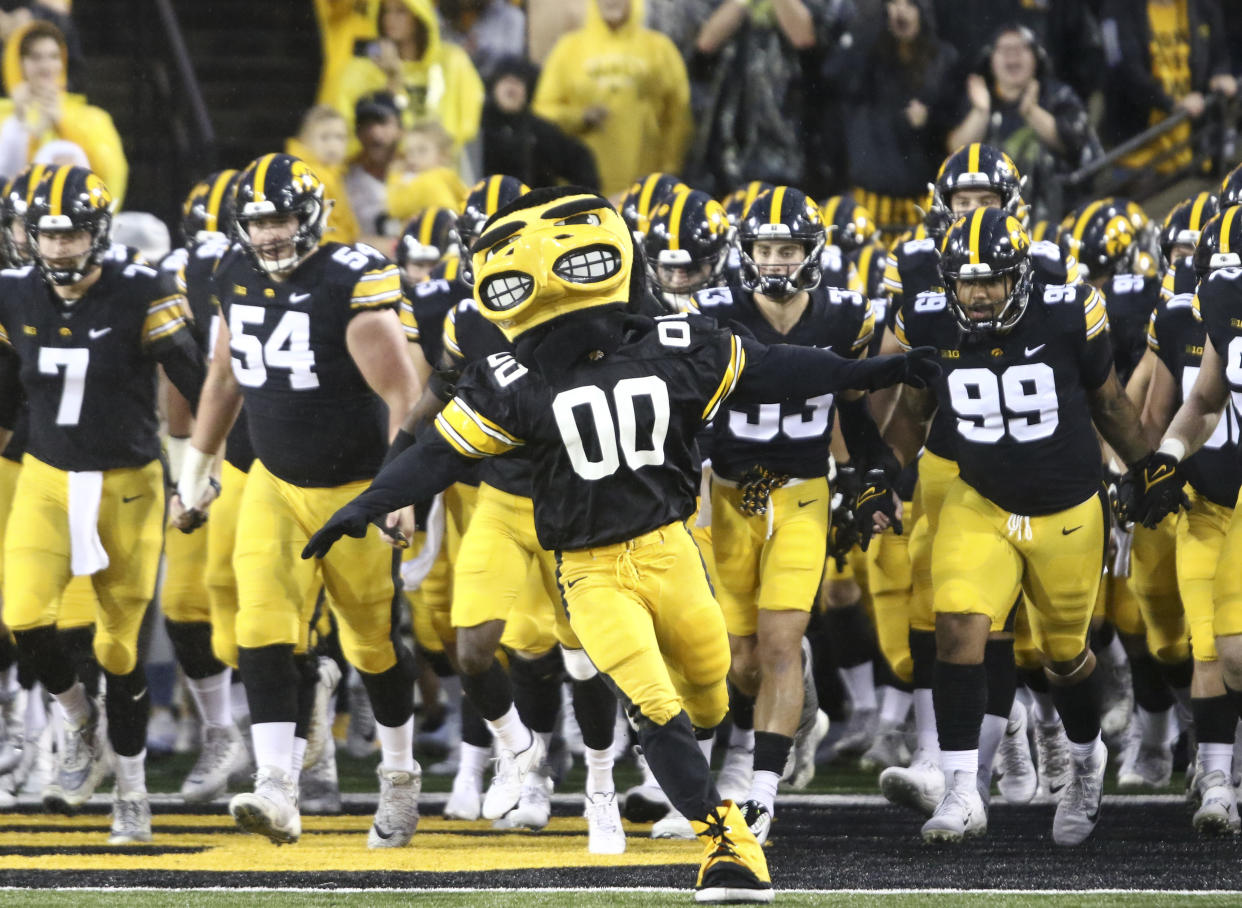 IOWA CITY, IOWA- SEPTEMBER 17:  Herky the Hawk leads members of the Iowa Hawkeyes onto the field before the match-up against the Nevada Wolf Pack at Kinnick Stadium, on September 17, 2022 in Iowa City, Iowa.  (Photo by Matthew Holst/Getty Images)