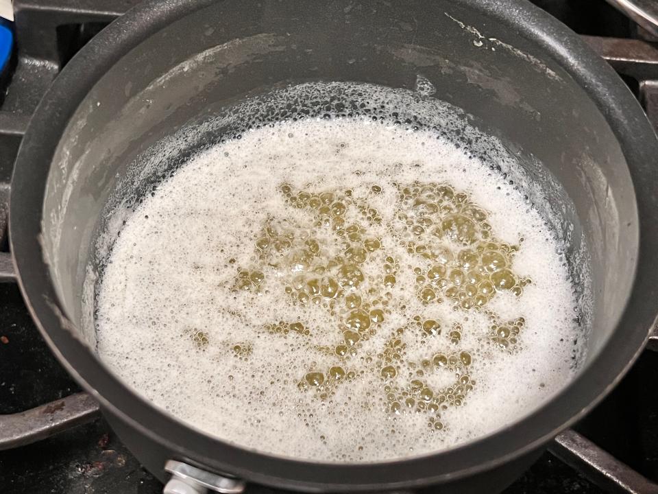 brown butter cooking in a sauce pan on a stove