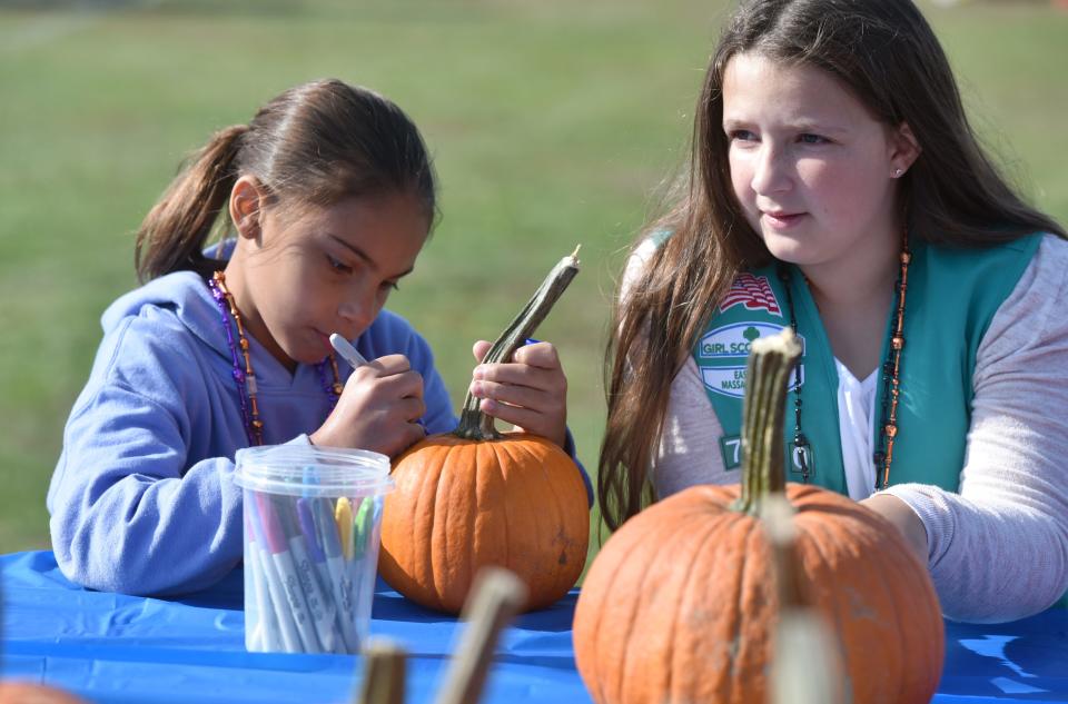 Girl Scouts Isabella Tillman, left, and Kensington Calvert staff their troop's table to decorate pumpkins at the 2021 Yarmouth Seaside Festival. This year's event will take place Saturday and Sunday at the Joshua Sears Memorial Field off Route 28 and on local beaches.