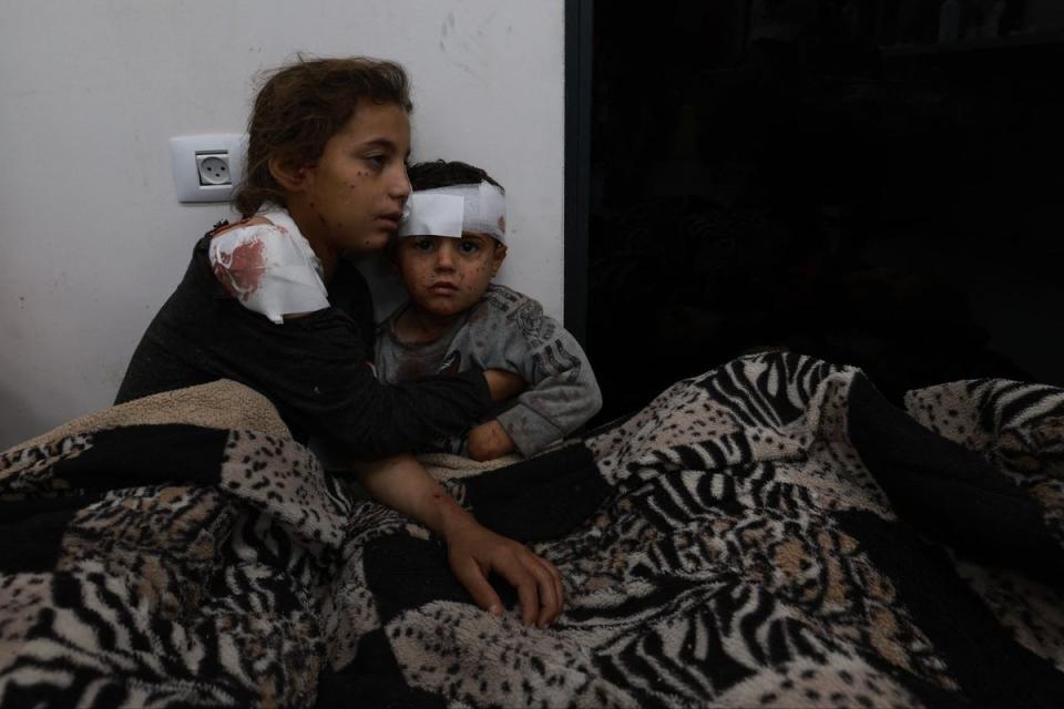 Wounded Palestinian girl Somay al-Najar comforts her brother Yamen (AFP via Getty Images)