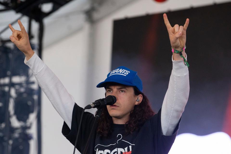 Neil Smith of Peach Pit holds up horns on the last day of Bonnaroo near Manchester, Tenn., on Sunday, June 18, 2023.