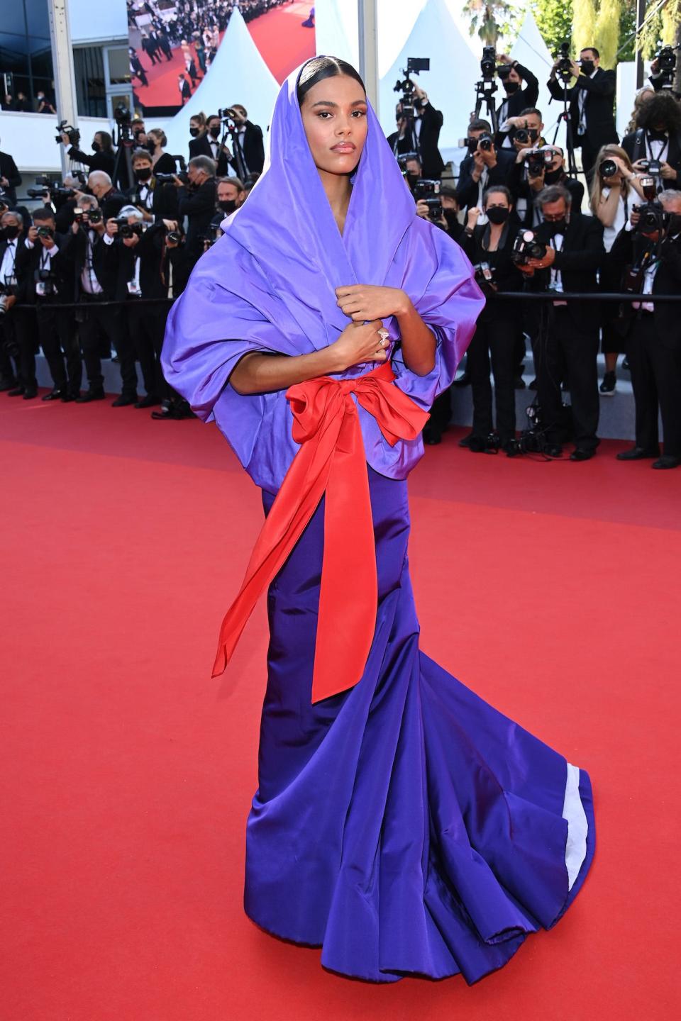 Tina Kunakey wears a purple dress at the 2021 Cannes Film Festival.