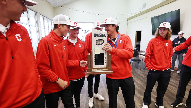 Crimson Cliffs players celebrate their win in the team championship during the 4A boys golf tournament at The Ridge Golf Club in West Valley City on Thursday, Oct. 12, 2023.