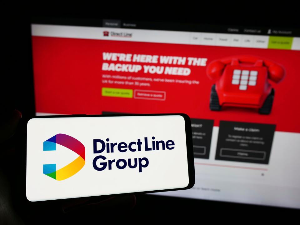 Stuttgart, Germany, 12-08-2023: Person holding smartphone with logo of British financial company Direct Line Insurance Group plc in front of website.