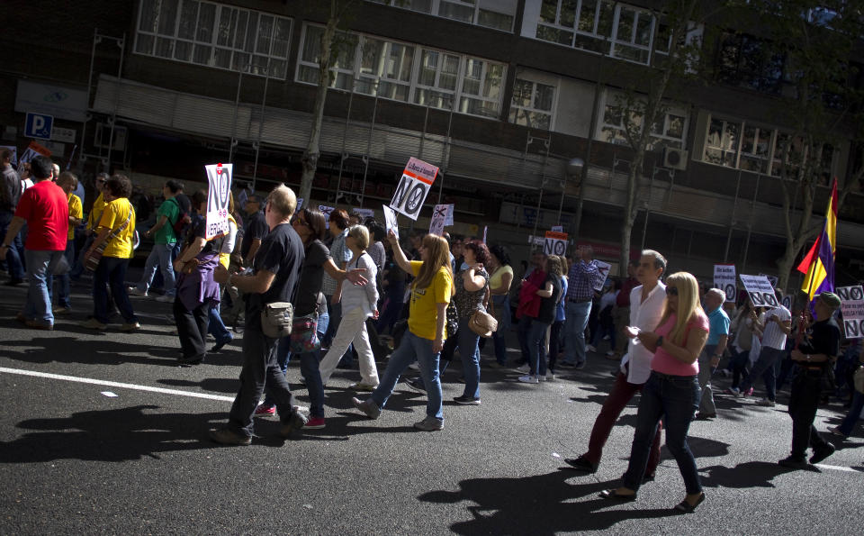 People hold banners against cuts during a demonstration in Madrid, Spain, Sunday, Oct. 7, 2012. Thousands of people called by 150 organizations are marching in 56 Spanish cities to protest punishing austerity cuts they say will only increase unemployment and job insecurity. (AP Photo/Alberto Di Lolli)