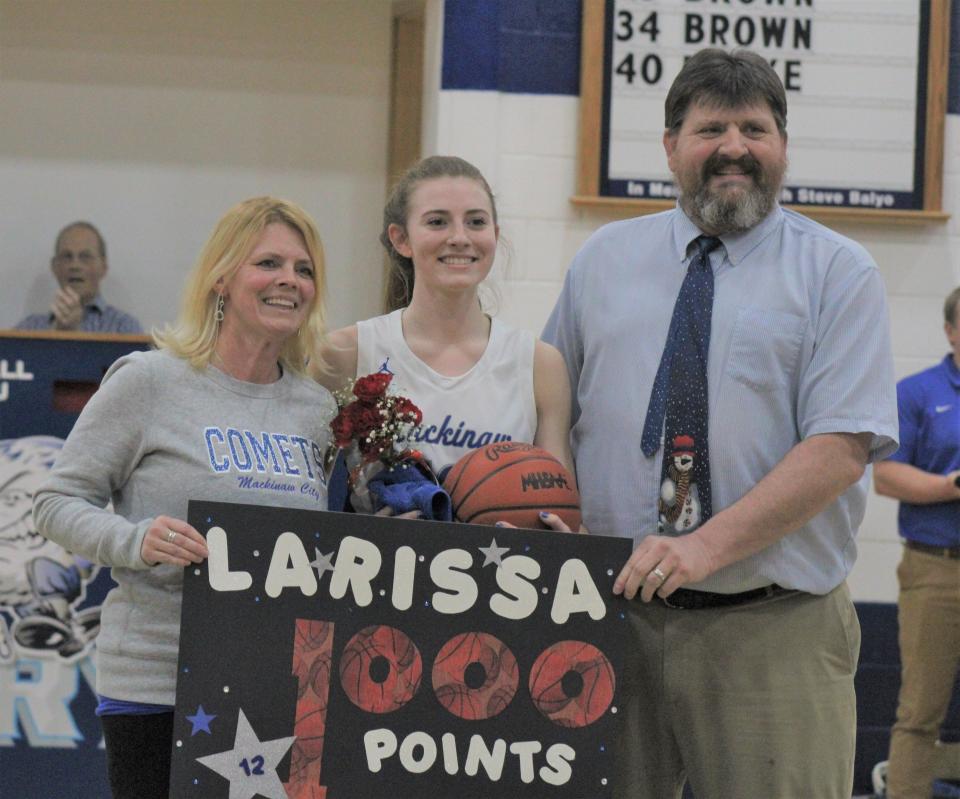 Mackinaw City senior Larissa Huffman reached 1,000 career points during Wednesday night's victory over Engadine. In this photo with Larissa are her parents, Heather, as well as Jake, Mackinaw City's head coach.