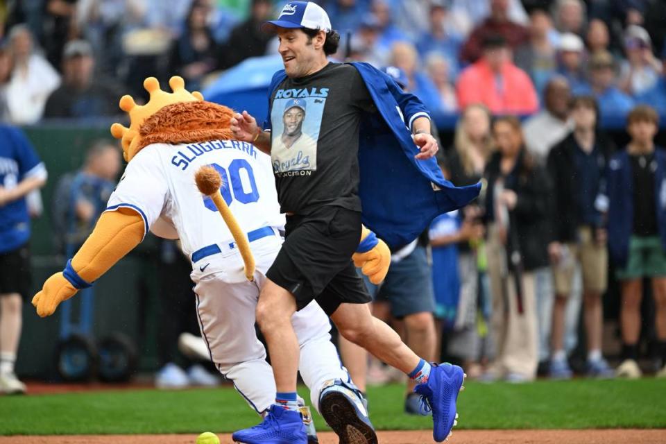 Paul Rudd runs for home base while Kansas City Royals mascot Sluggerrr attempts to field the ball during the Big Slick Celebrity Softball Game.