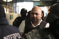 former Salvadoran congressman Roberto Silva Pereira arrives at the Judicial Center of San Salvador, El Salvador, Wednesday, Jan. 8, 2020. Silva Pereira who was a congressman from El Salvador's conservative National Conciliation Party was arrested Wednesday following his deportation from the United States, where he fled in 2007. He allegedly bribed local officials to grant unfair contracts to front companies. (AP Photo/Salvador Melendez)