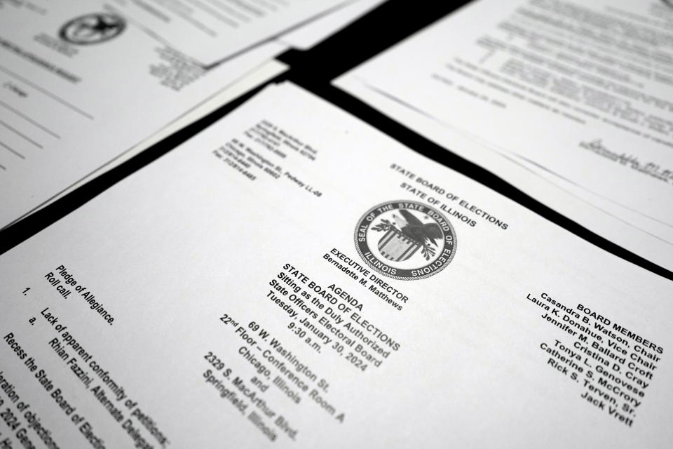 Information papers are seen on a table during the Illinois State Board of Elections meeting in Chicago, Tuesday, Jan. 30, 2024. Illinois’ election board kept former President Donald Trump on the state’s primary ballot, a week before the U.S. Supreme Court hears arguments on whether the Republican’s role in the Jan. 6, 2021, attack on the U.S. Capitol disqualifies him from the presidency. (AP Photo/Nam Y. Huh)