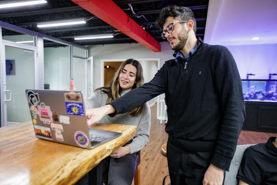 Jules Crespo, a videographer at 223 Agency, left, and Joe Larazo, a managing director at 223 Agency, work together on a project Wednesday, Jan. 12, 2022.