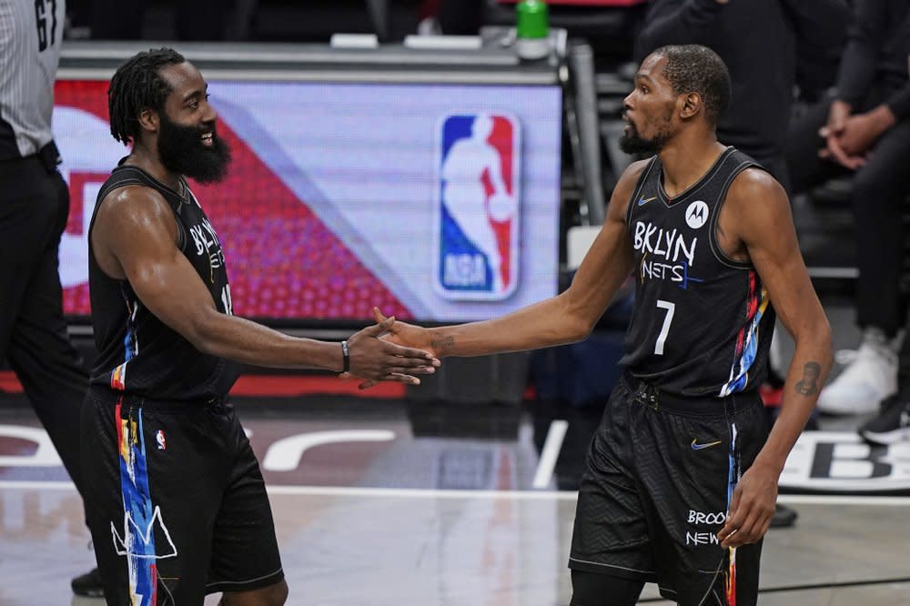 Brooklyn Nets forward Kevin Durant (7) congratulates Brooklyn Nets guard James Harden (13) during the final seconds of the fourth quarter of an NBA basketball game against the Los Angeles Clippers, Tuesday, Feb. 2, 2021, in New York. (AP Photo/Kathy Willens)