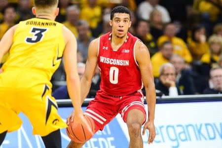 Nov 30, 2018; Iowa City, IA, USA; Wisconsin Badgers guard D'Mitrik Trice (0) controls the ball as Iowa Hawkeyes guard Jordan Bohannon (3) defends during the first half at Carver-Hawkeye Arena. Jeffrey Becker-USA TODAY Sports