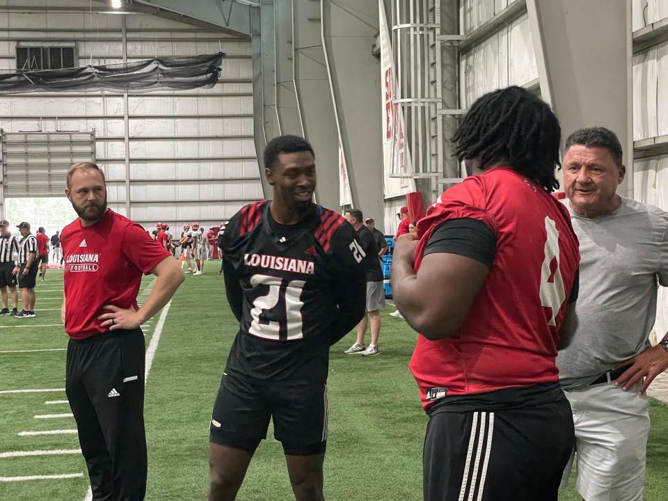 Former LSU football coach Ed Orgeron talks with Louisiana football players Trey Amos (21) and Zi'Yon Hill-Green (4) at the team's first preseason scrimmage Saturday, Aug. 13 inside the Leon Moncla Indoor Practice Facility.