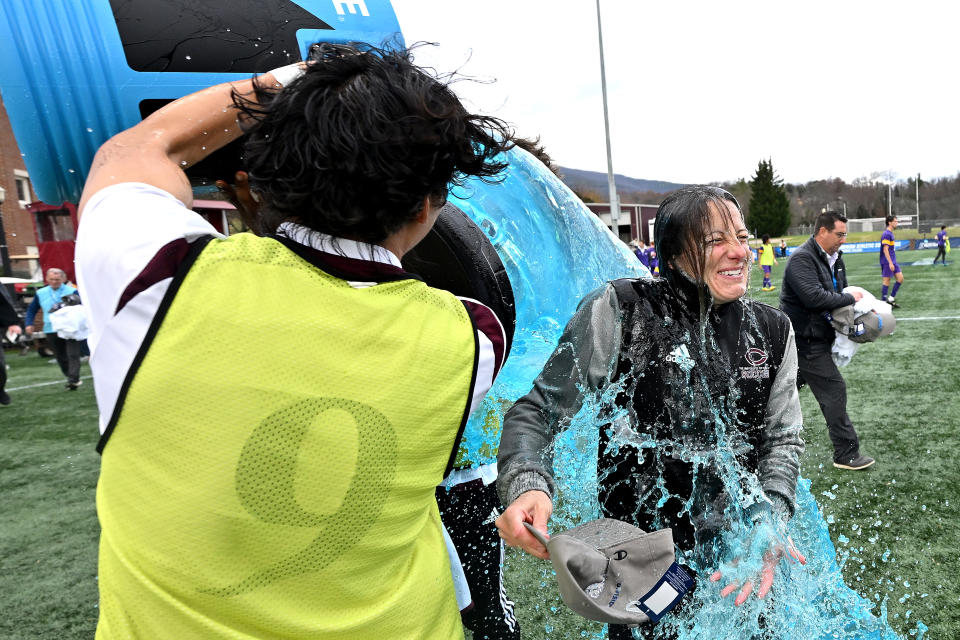 SALEM, VA - DECEMBER 03: Players douse head coach Julianne Sitch of the University of Chicago Maroons after their win against the Williams College Ephs during the Division III Men’s Soccer Championship held at Kerr Stadium on December 3, 2022 in Salem, Virginia. The Maroons won the national championship, 2-0. (Photo by Grant Halverson/NCAA Photos via Getty Images)