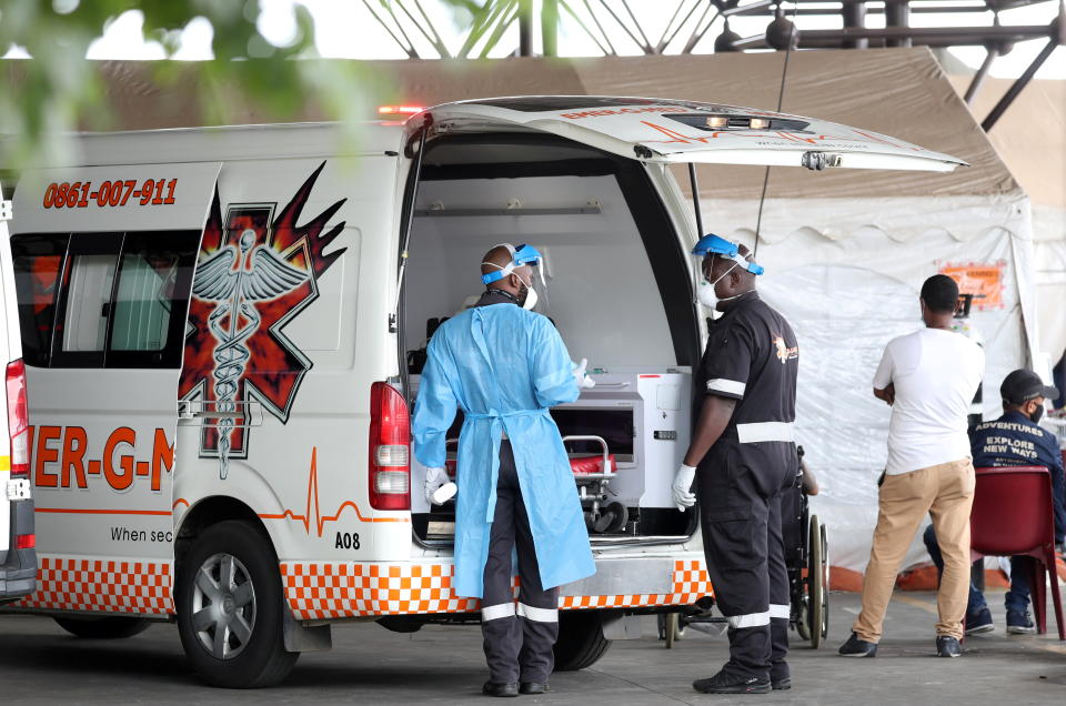 Health workers chat near an ambulance  at the parking lot of the Steve Biko Academic Hospital, amid a nationwide coronavirus disease (COVID-19) lockdown, in Pretoria, South Africa, January 11, 2021. REUTERS/Siphiwe Sibeko