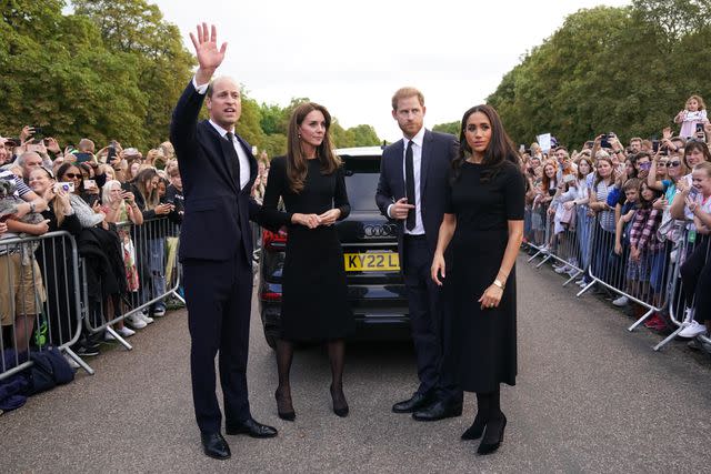 <p>Getty</p> Prince William, Kate Middleton, Prince Harry and Meghan Markle greet members of the public on the long Walk at Windsor Castle following the death of Queen Elizabeth in September 2022.