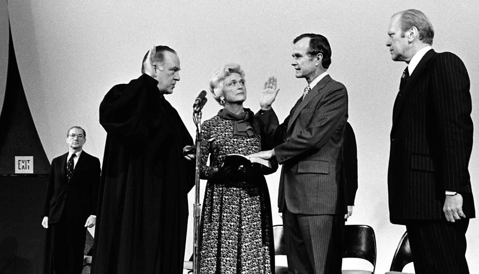 President Gerald Ford (far right) and Barbara Bush watch as Justice Potter Stewart swears in George H.W. Bush as director of the CIA at the agency's Langley, Virginia, headquarters on Jan. 26, 1976.