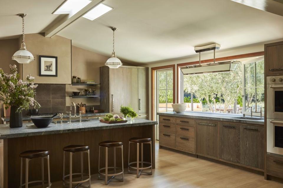 a kitchen with a bar and stools