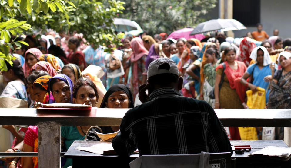 In photo taken Wednesday, Aug. 29, 2012, unemployed educated Indian women stand in queues to register themselves at the Employment Exchange Office in Allahabad, India. India, with the world's largest chunk of illiterates at over 250 million, has to invest heavily in education and skills training, said Ashish Bose, a leading demographer. While millions of job seekers have impressive sounding diplomas, many don't have the skills promised by those certificates from colleges and technical institutes with poor standards. (AP Photo/Rajesh Kumar Singh)