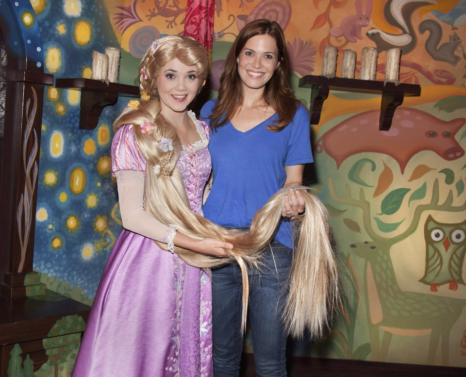 Singer/actress Mandy Moore poses with Rapunzel at Disneyland Park October 15, 2012 in Anaheim, California.  Moore provided the voice for Rapunzel in Disney's 2010 animated film 'Tangled' and in this year short, 'Tangled Ever After.'  (Photo by Paul Hiffmeyer/Disney Parks via Getty Images)