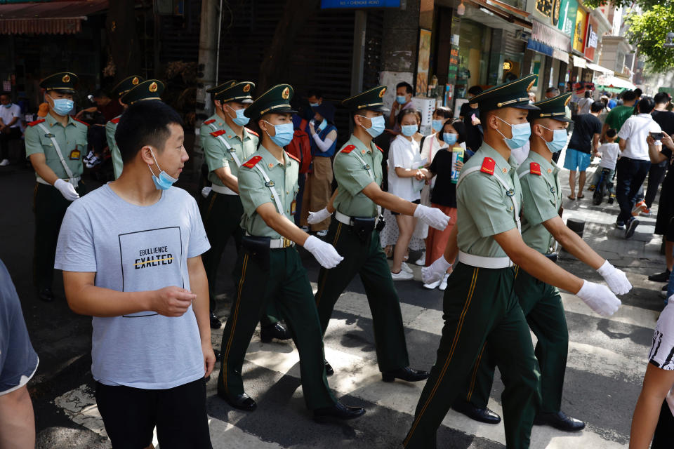 Chinese paramilitary policemen march near the United States Consulate in Chengdu in southwest China's Sichuan province on Sunday, July 26, 2020. China ordered the United States on Friday to close its consulate in the western city of Chengdu, ratcheting up a diplomatic conflict at a time when relations have sunk to their lowest level in decades. (AP Photo/Ng Han Guan)