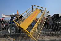 A police barricade lies on the road divider during a tractor rally by farmers as they continue to demonstrate against the central government's recent agricultural reforms in New Delhi on January 26, 2021. (Photo by Money SHARMA / AFP) (Photo by MONEY SHARMA/AFP via Getty Images)