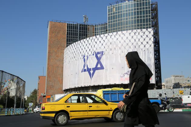 Giant anti-Israel banners are hanged on buildings in Tehran.