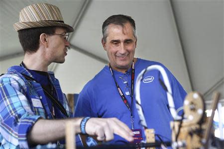 Intel CEO Brian Krzanich (R) listens to Node.js Sandbox creator Michael McCool (L) at the Maker's Faire in San Mateo, California May 17, 2014. REUTERS/Elijah Nouvelage