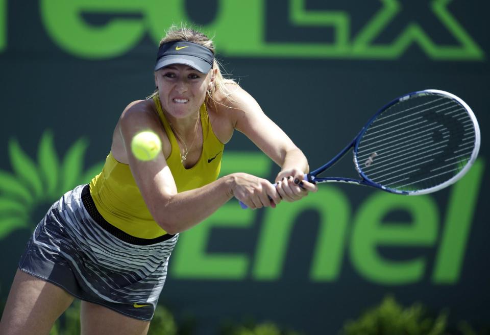 Maria Sharapova, of Russia, returns to Petra Kvitova, of Czech Republic, at the Sony Open Tennis tournament, Tuesday, March 25, 2014, in Key Biscayne, Fla. (AP Photo/Lynne Sladky)