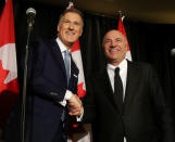 Conservative Party of Canada's leadership candidates Kevin O'Leary and Maxime Bernier shake hands at a news conference in Toronto, Canada April 26, 2017. O'Leary announced his withdrawal from the race and his support for Bernier. REUTERS/Fred Thornhill