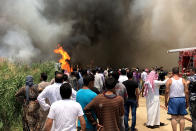 <p>Smoke rises after fire breaks out due to an unknown reason at the Qob Elias refugee camp at the Beqaa valley in Lebanon on July 1, 2017. (Hasan Jarrah/Anadolu Agency/Getty Images) </p>