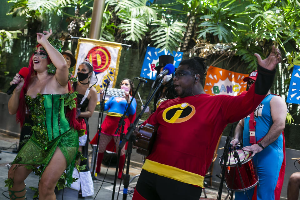 Musicians of the "Desliga da Justica" street band perform in Rio de Janeiro, Brazil, Sunday, Feb. 14, 2021. Their performance was broadcast live on social media for those who were unable to participate in the carnival due to COVID restrictions after the city's government officially suspended Carnival and banned street parades or clandestine parties. (AP Photo/Bruna Prado)