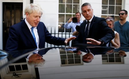 Boris Johnson is seen outside his office in London