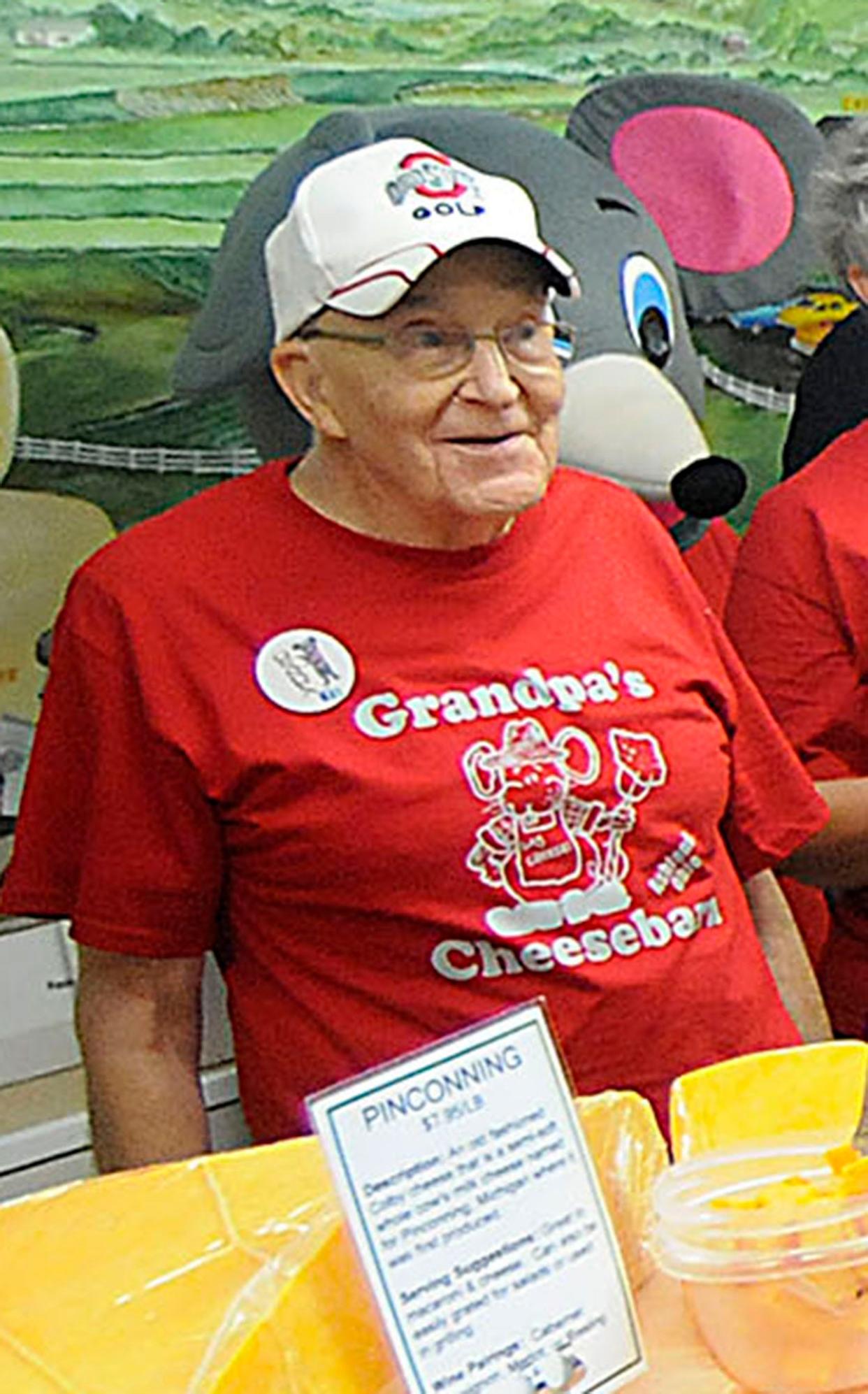 "Grandpa" Dick Baum is seen behind the cheese counter of Grandpa's Cheese Barn in June 2013.