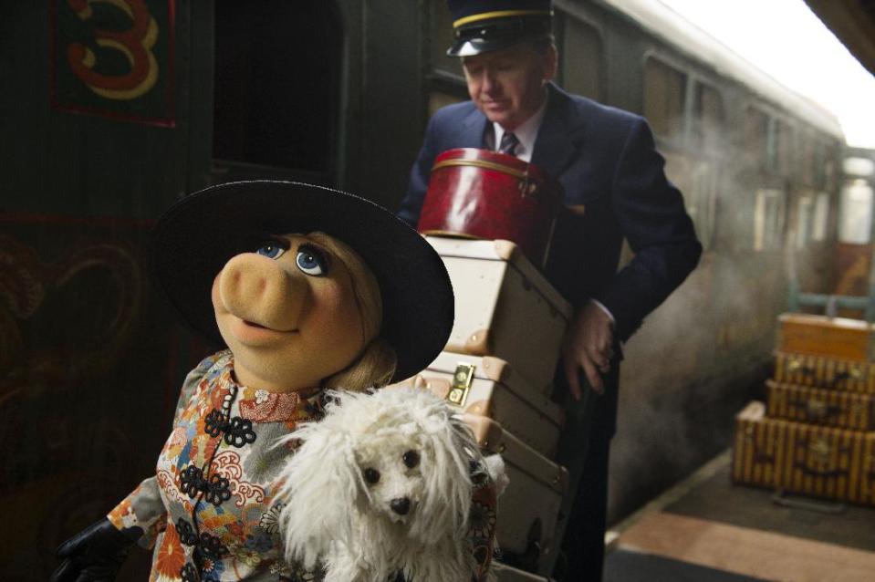 This image released by Disney shows muppet character Miss Piggy and her dog Foo-Foo in a scene from "Muppets Most Wanted." (AP Photo/Disney, Jay Maidment)