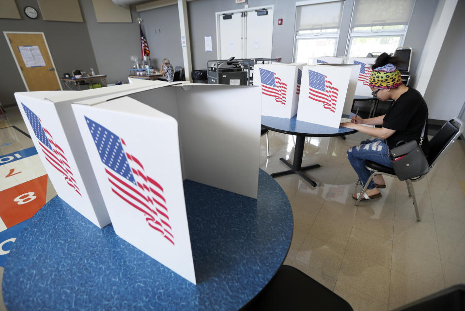 Sierra Smith, of Des Moines, Iowa, fills out her ballot in Iowa's Primary Election at the Polk County Central Senior Center, Tuesday, June 2, 2020, in Des Moines, Iowa. (AP Photo/Charlie Neibergall)