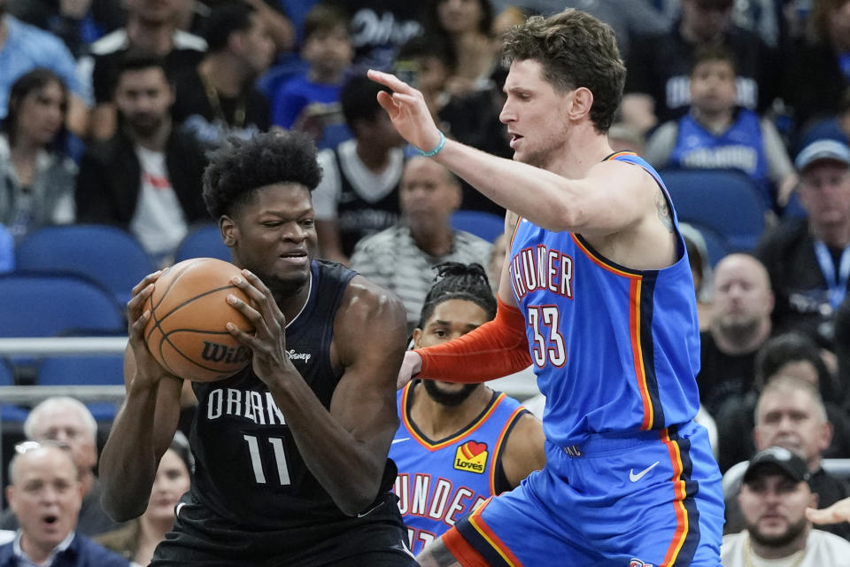 Orlando Magic's Mo Bamba (11) goes to the basket against Oklahoma City Thunder's Mike Muscala (33) during the first half of an NBA basketball game Wednesday, Jan. 4, 2023, in Orlando, Fla. (AP Photo/John Raoux)