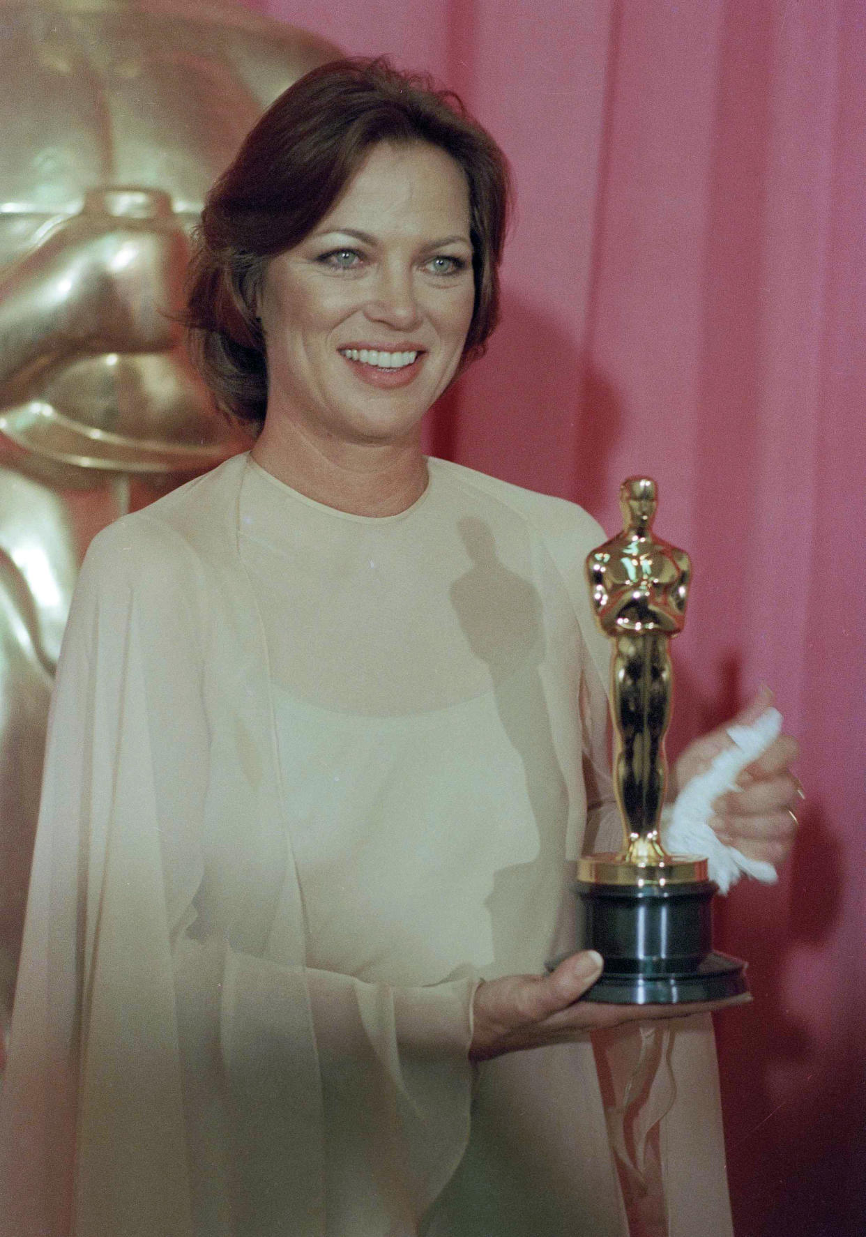 FILE - Louise Fletcher holds the Academy Award she won for her leading role in "One Flew Over The Cuckoo's Nest" in Los Angeles, March 30, 1976. Fletcher, a late-blooming star whose riveting performance as the cruel and calculating Nurse Ratched in “One Flew Over the Cuckoo's Nest” set a new standard for screen villains and won her an Academy Award, died Friday, Sept. 23, 2022, at age 88. (AP Photo/File)