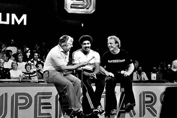 CWMBRAN, WALES - SEPTEMBER 25: Ron Pickering of the BBC interviews Daley Thompson (centre) and Brian Jacks during the UK final of Superstars at Cwmbran Stadium, Cwmbran, Wales, UK on Saturday and Sunday 25/26th September 1979. The program was broadcast by the BBC in February 1980 with Jacks the tournament winner and Thompson finishing 3rd. (Photo by David Finch/Getty Images)
