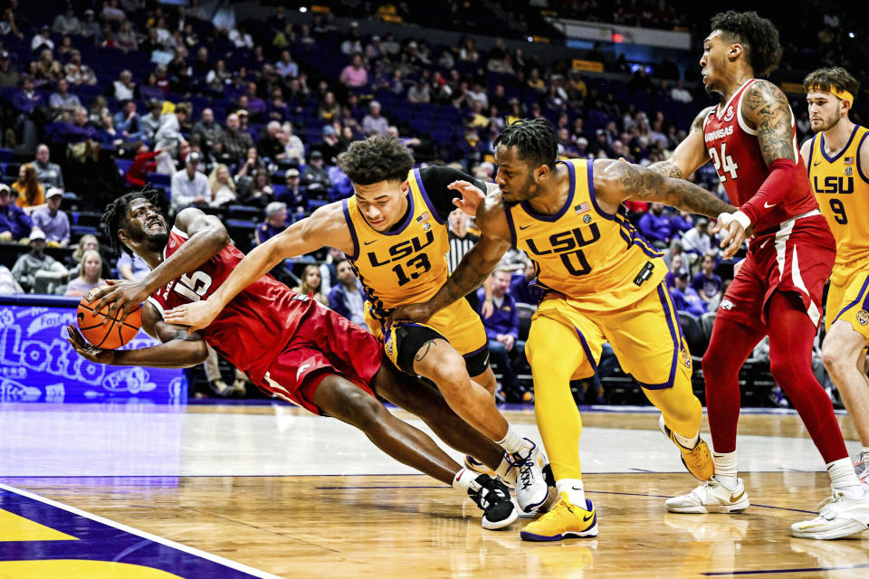 Arkansas forward Makhi Mitchell (15) manages to release a pass while falling down during an NCAA college basketball game against LSU at Pete Maravich Assembly Center, Saturday, Feb. 3, 2024, Baton Rouge, La. (Javier Gallegos/The Advocate via AP)