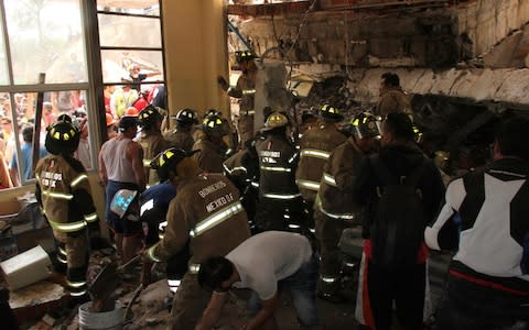 Rescue workers inside the school - Credit: AP