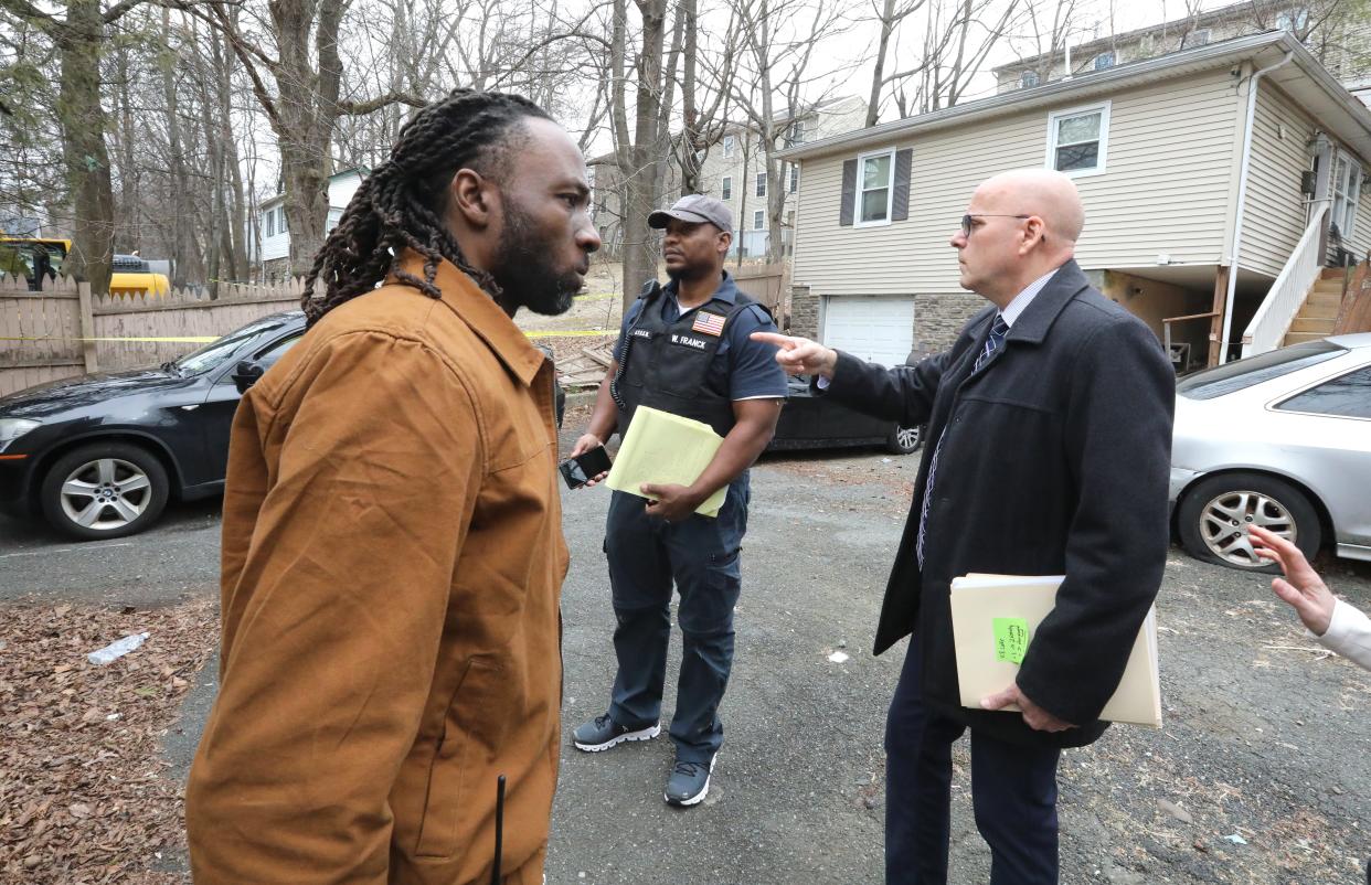 From left, Rockland County Building Inspector, Jack Lavalasse, Fire Inspector, Willer Franck and Director of the Office of Buildings and Codes, Ed Markunas inspect a house next to a two-family house where there was a fatal fire on Lake St. in Spring Valley March 6, 2023.