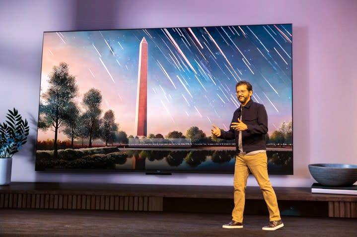 Daniel Rausch, VP of Fire TV and Alexa for Amazon, in front of an AI-generated photo on Fire TV.