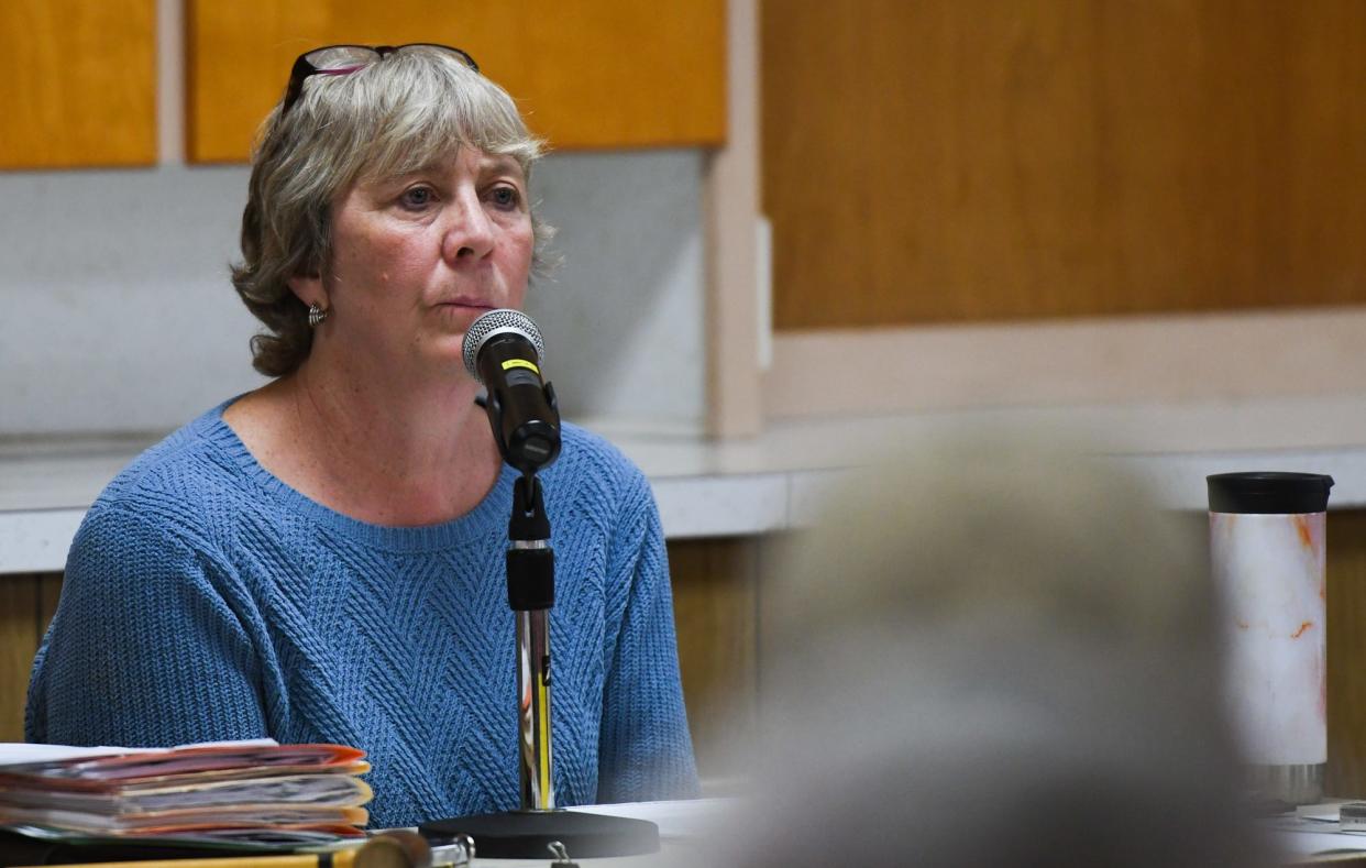 Eagle Township supervisor Patti Schafer listens as community members give their opinions on the proposed megasite and voice their disdain with concerns about lack of transparency from township officials, Thursday, May 9, 2023.
