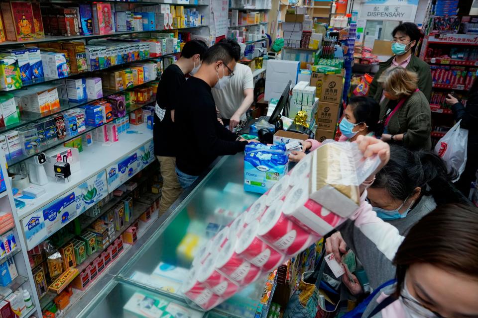 People purchase household supplies at a pharmacy as residents worry about a shortage of supplies in Hong Kong, Monday, Feb. 28, 2022.