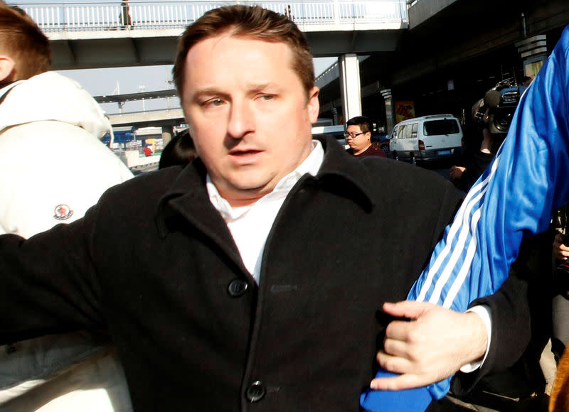 Canadian businessman Michael Spavor arrives next to the former NBA basketball player Dennis Rodman (not pictured) after a trip to North Korea, at Beijing Capital International Airport, Beijing, China January 13, 2014. Picture taken January 13, 2014. REUTERS/Kim Kyung-Hoon