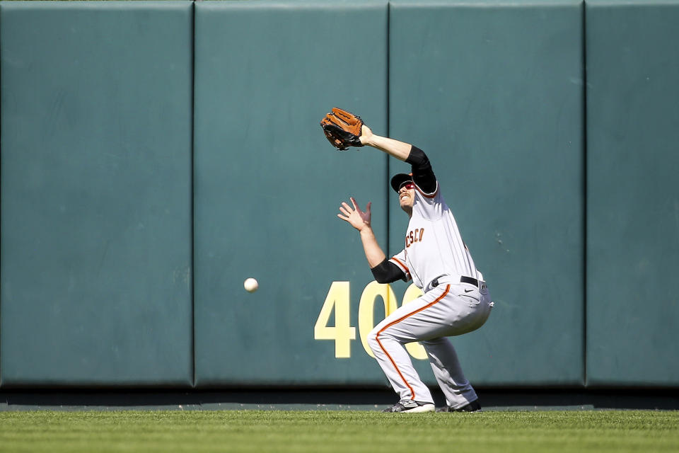 San Francisco Giants center fielder Austin Slater (13) is unable to catch a fly ball hit by St. Louis Cardinals' Paul Goldschmidt during the seventh inning of a baseball game Saturday, May 14, 2022, in St. Louis. (AP Photo/Scott Kane)