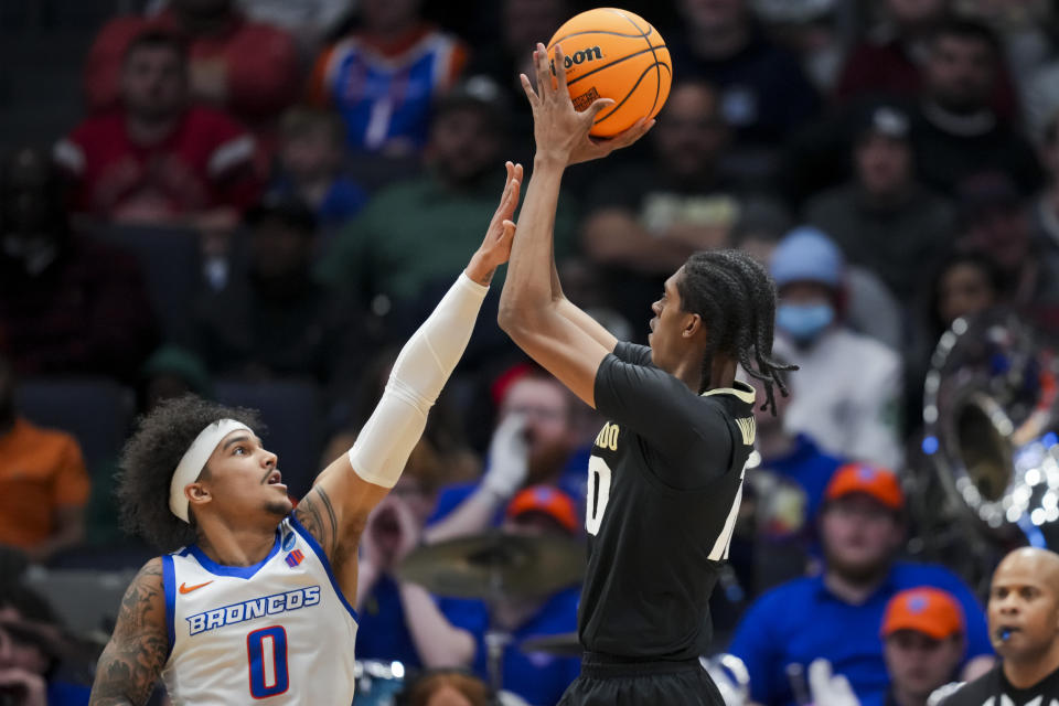 Colorado forward Cody Williams, right, shoots against Boise State guard Roddie Anderson III, left, during the first half of a First Four game in the NCAA men's college basketball tournament Wednesday, March 20, 2024, in Dayton, Ohio. (AP Photo/Aaron Doster)